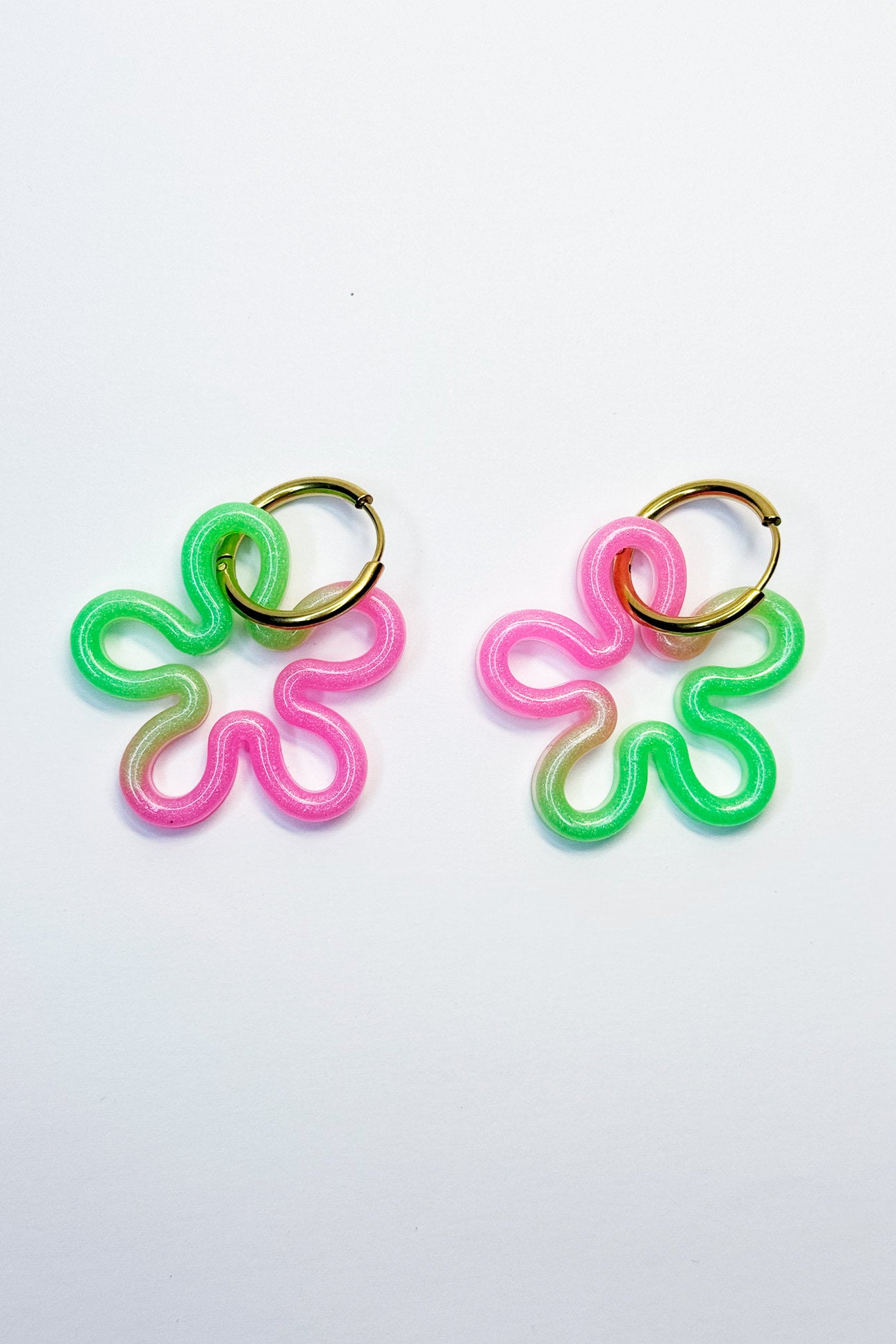 Su diseño combina colores fluorescentes que crean un efecto llamativo y luminoso, ideal para destacar en cualquier ocasión.